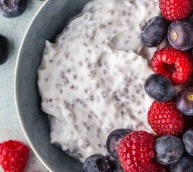 easy high protein greek yogurt bowl with chia seeds berries, Close up overhead shot of a Greek yogurt breakfast bowl Chia seeds are mixed in to the creamy yogurt and half the bowl is topped with fresh raspberries and blueberries