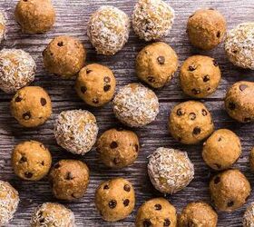 protein balls recipe 3 delicious flavor variations, A horizontal close up overhead shot of three flavors of protein balls all randomly filling up the space on a wooden table Some are coated in coconut and most have chocolate chips