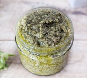 black garlic vegan pesto, A glass pot of black garlic vegan pesto sitting on a white surface