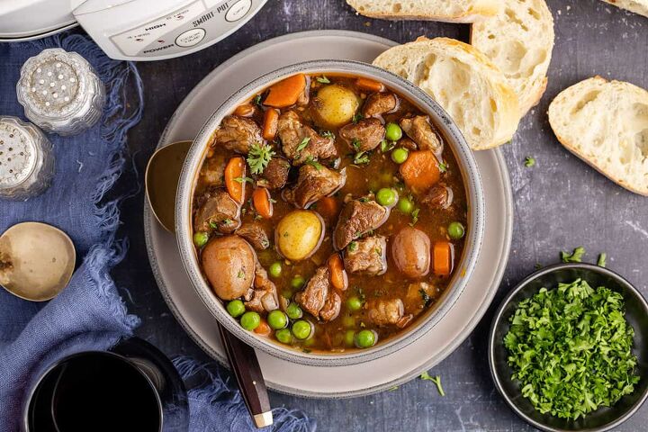 lamb stew crock pot, Crock Pot Lamb Stew in a bowl from above with a slow cooker and bread beside