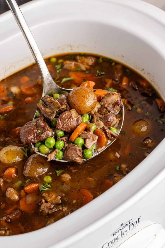 lamb stew crock pot, Crock Pot Lamb Stew in a ladle over a slow cooker