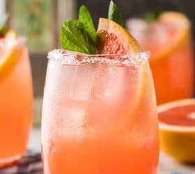 paloma cocktail recipe, Close up side shot of a paloma drink This pink cocktail is garnished with a grapefruit wedge and a sprig of mint