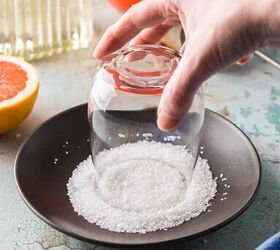 paloma cocktail recipe, Rimming a glass with salt by inverting the glass into coarse salt on a small black plate