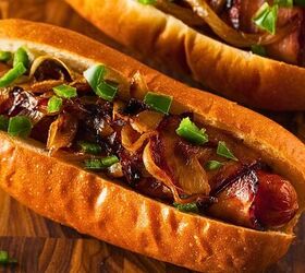 air fryer bacon wrapped hot dogs crispy bacon hot dog recipe, overhead imge of two bacon wrapped hot dogs in buns