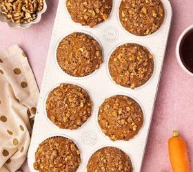 easy carrot cake muffins with cheesecake filling no frosting needed, Carrot cake muffins with cheesecake filling and walnut streusel topping freshly baked in a muffin tray golden and domed