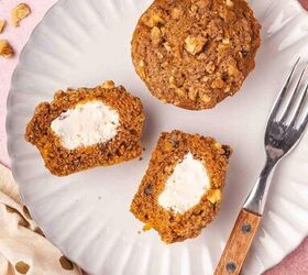 easy carrot cake muffins with cheesecake filling no frosting needed, Moist carrot cake muffin cut open on a plate revealing a rich cheesecake center and topped with crunchy walnut streusel