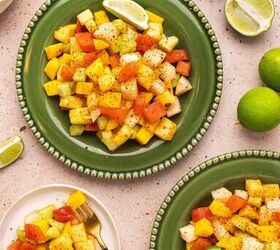 the best mexican fruit salad with tajin seasoning, Bright fruit salad on a serving plate topped with chili lime dressing and Taj n seasoning