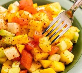 the best mexican fruit salad with tajin seasoning, Fresh mixed fruit salad with Taj n served neatly on a round plate
