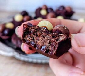 crunchy chocolate puffed rice easter cups 4 ingredients, A hand holding a half eaten chocolate puffed rice Easter cup