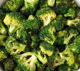 air fryer broccoli, A bowl filled with roasted broccoli florets showing crispy browned edges and vibrant green color