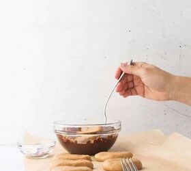 cashew butter reese s eggs gluten free and dairy free recipe, hand dipping the cashew butter egg into the melted dairy free chocolate