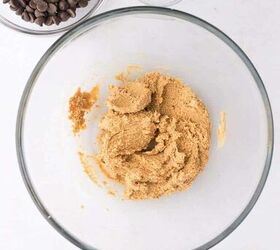 cashew butter reese s eggs gluten free and dairy free recipe, The cashew butter coconut flour and maple syrup mixed together Chocolate chips and coconut oil are in bowls beside the mixture ready for the next step