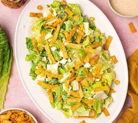 easy mexican caesar salad recipe with creamy lime dressing, Fresh Mexican Caesar salad served on a large platter with romaine lettuce Cotija cheese roasted corn tortilla strips and creamy lime dressing