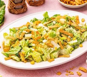 easy mexican caesar salad recipe with creamy lime dressing, Restaurant style Mexican Caesar salad arranged on a platter with crispy tortilla strips and Cotija cheese on top