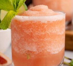 non alcoholic frozen paloma, close up of Non alcoholic frozen paloma served in a glass and garnished with a lime round and fresh mint