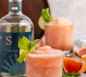non alcoholic frozen paloma, Non alcoholic frozen paloma served in a glass and garnished with a lime round and fresh mint with slices of grapefruit beside and bottle of non alcoholic tequila
