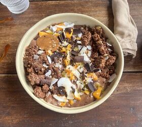 chocolate smoothie bowl with chocolate granola coconut flakes mango