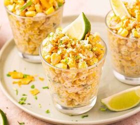 easy mexican street corn cups recipe elote en vaso esquites, Bowl of Mexican street corn served in individual cups with lime wedges and chili seasoning