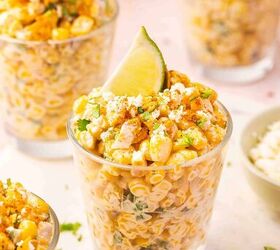 easy mexican street corn cups recipe elote en vaso esquites, Close up of esquites in cups with creamy corn spices cilantro and lime wedges on top