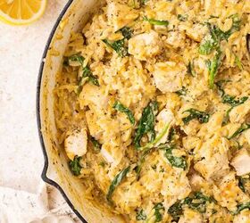 lemon chicken orzo pasta one pan, A skillet filled with creamy orzo pasta pieces of chicken and spinach The dish is garnished with black pepper Next to the skillet are lemon halves and a small bowl of grated cheese