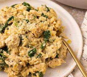 lemon chicken orzo pasta one pan, A plate of creamy chicken and spinach orzo garnished with grated cheese served with a gold fork on a light colored plate A patterned napkin and a dish of orzo are visible beside the plate