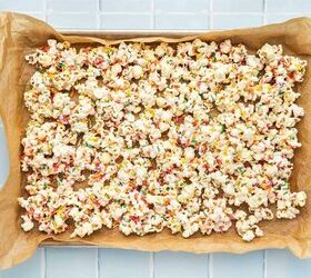 3 ingredient funfetti popcorn recipe easy no bake treat, Sweet popcorn coated in white almond bark and topped with rainbow sprinkles resting in a baking tray to set into clusters