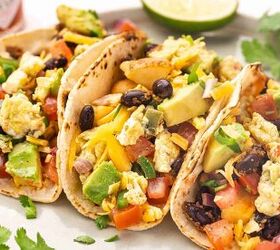 easy breakfast tacos with pico scrambled eggs, Close up of a loaded breakfast taco with pico scrambled eggs crispy potatoes black beans and cheese