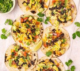 easy breakfast tacos with pico scrambled eggs, Breakfast tacos topped with pico scrambled eggs avocado cilantro and lime on a serving platter