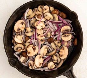 easy egg white frittata fluffy high protein, A cast iron skillet filled with sliced mushrooms and thinly sliced red onions ready to be cooked on a light colored surface