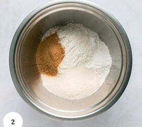 blueberry yogurt muffins with crumble topping, A metal mixing bowl containing separate piles of brown sugar white flour and granulated sugar on a light marble surface ingredients ready for blueberry yogurt muffins A white circle with the number 2 is in the bottom left corner