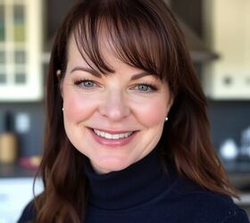 creamy coleslaw with celery seed, A woman with straight brown hair and bangs smiles warmly wearing a dark turtleneck sweater She is indoors with a modern kitchen featuring cabinets and a range hood blurred in the background