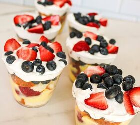 easy no bake parfait cups with fresh berries, Finished parfait cups with layers of cake vanilla pudding strawberries blueberries and whipped topping