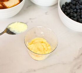 easy no bake parfait cups with fresh berries, Spoonful of vanilla pudding added over pound cake in a clear parfait cup