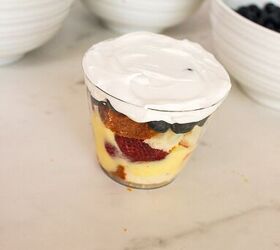 easy no bake parfait cups with fresh berries, Whipped topping spread over the top of a layered berry parfait cup dessert