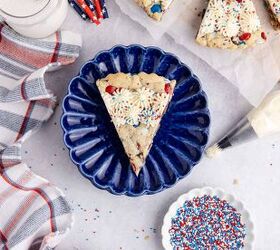this red white and blue cookie cake is always a hit, Red White and Blue Cookie Cake from above with a slice on a plate a glass of milk and sprinkles near