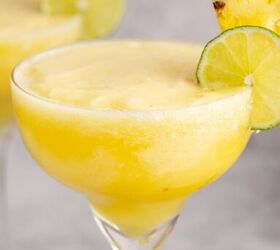 frozen non alcoholic pineapple margarita, Frozen Non Alcoholic Pineapple Margarita close up with a lime round and pineapple on the rim