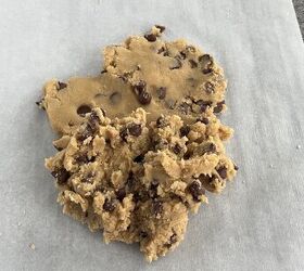 easy no bake cookie dough bark edible safe to eat, A mound of chocolate chip cookie dough sits on a sheet of parchment paper atop a gray countertop ready to be shaped or baked
