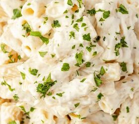 lemon ricotta pasta without heavy cream, Close up of creamy rigatoni pasta covered in a white sauce garnished with chopped fresh parsley