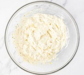 lemon ricotta pasta without heavy cream, A clear glass mixing bowl filled with a creamy white cheese mixture sits on a white marble countertop