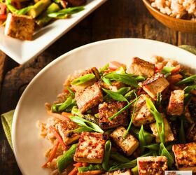 tofu stir fry easy crispy tofu stir fry recipe, Tofu stir fry on a plate over rice with a serving dish of it next to the plate