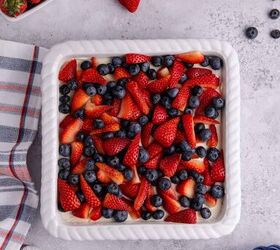 red white and blue pretzel salad made in a square pan, Red White and Blue Pretzel Salad from above with berries around it