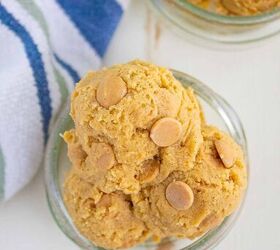 edible peanut butter cookie dough no eggs no bake, Scoops of cookie dough with peanut butter chips in a small glass bowl placed on a light surface next to a striped blue green and white cloth