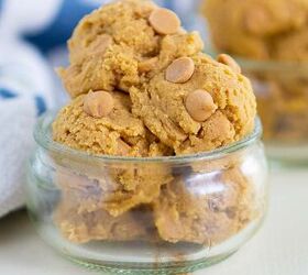 edible peanut butter cookie dough no eggs no bake, A small glass bowl filled with several scoops of cookie dough topped with peanut butter chips with more cookie dough in the background and a striped cloth nearby