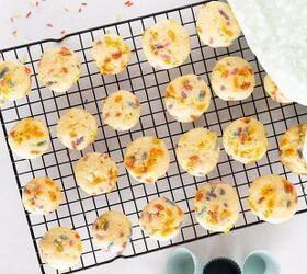 easy birthday cake mini muffins with sprinkles, Birthday cake mini muffins are cooling on a wire rack with rainbow sprinkles visible on top