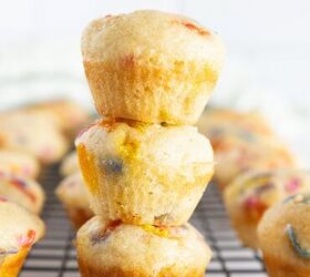 easy birthday cake mini muffins with sprinkles, Three stacked birthday cake mini muffins with rainbow sprinkles on a cooling rack