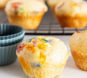 easy birthday cake mini muffins with sprinkles, Birthday cake mini muffin with colorful sprinkles beside silicone muffin liners on a white surface