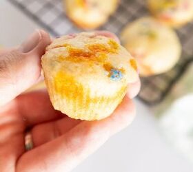 easy birthday cake mini muffins with sprinkles, Hand holding a birthday cake mini muffin with colorful sprinkles and blurred muffins in the background