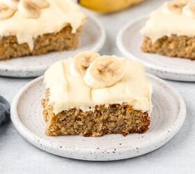 banana cake made with fresh milled flour, Slices of banana cake with cream cheese frosting in 3 saucer plates