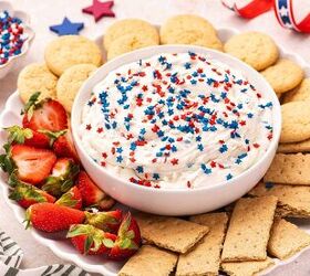 easy red white and blue funfetti cake dip recipe, 4th of July dessert dip served on a platter with strawberries graham crackers and vanilla wafers arranged around it