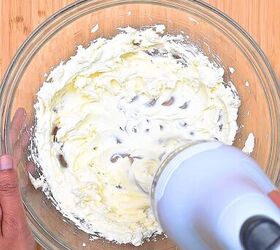 easy red white and blue funfetti cake dip recipe, Softened cream cheese being beaten in a mixing bowl until smooth and fluffy for funfetti cake dip base